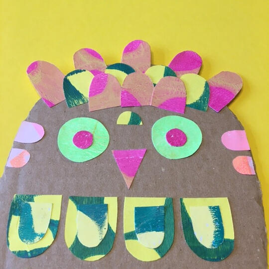 Owl made of cardboard and cut out shapes of paper to create a collage