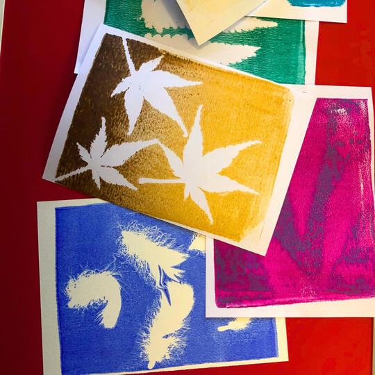 Gel plate print featuring leaves and natural textures in layered colours