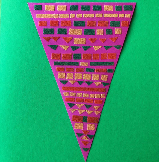 Pink triangle with coloured sand shapes green background