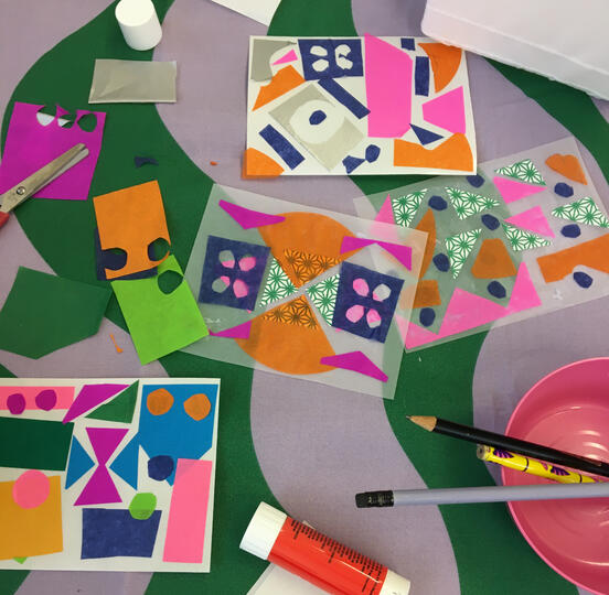 Shapes cut out and stuck on to a5 paper and tracing paper, glue stick, scissors and pencils in pink bowl