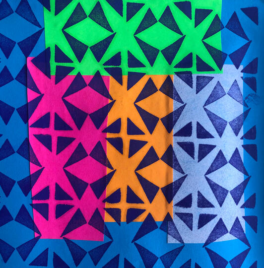 Rectangular pink green blue and orange background printed over with dark blue repeat triangles