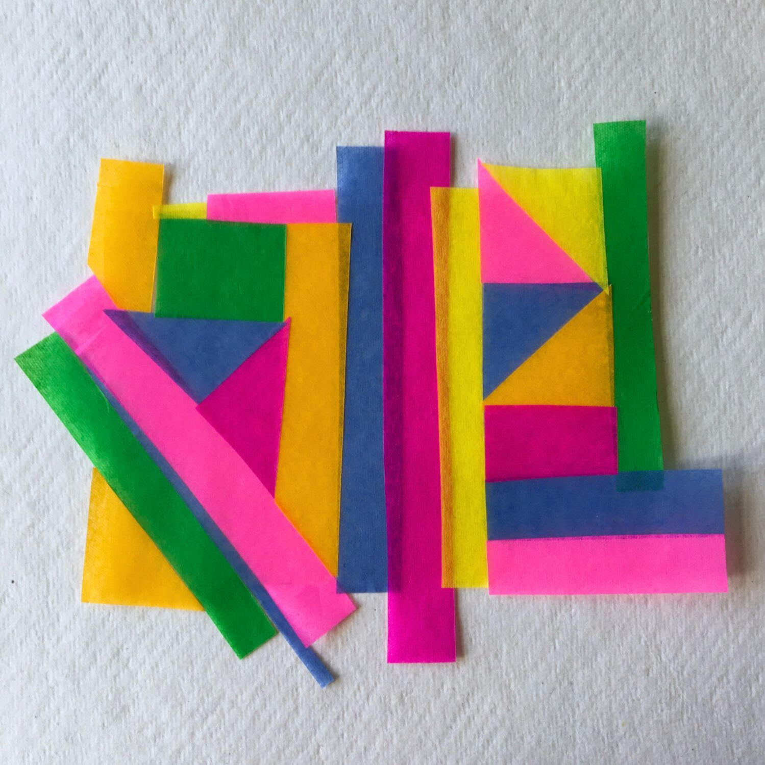 Adult and child hands creating colourful paper collages at a family arts and crafts workshop