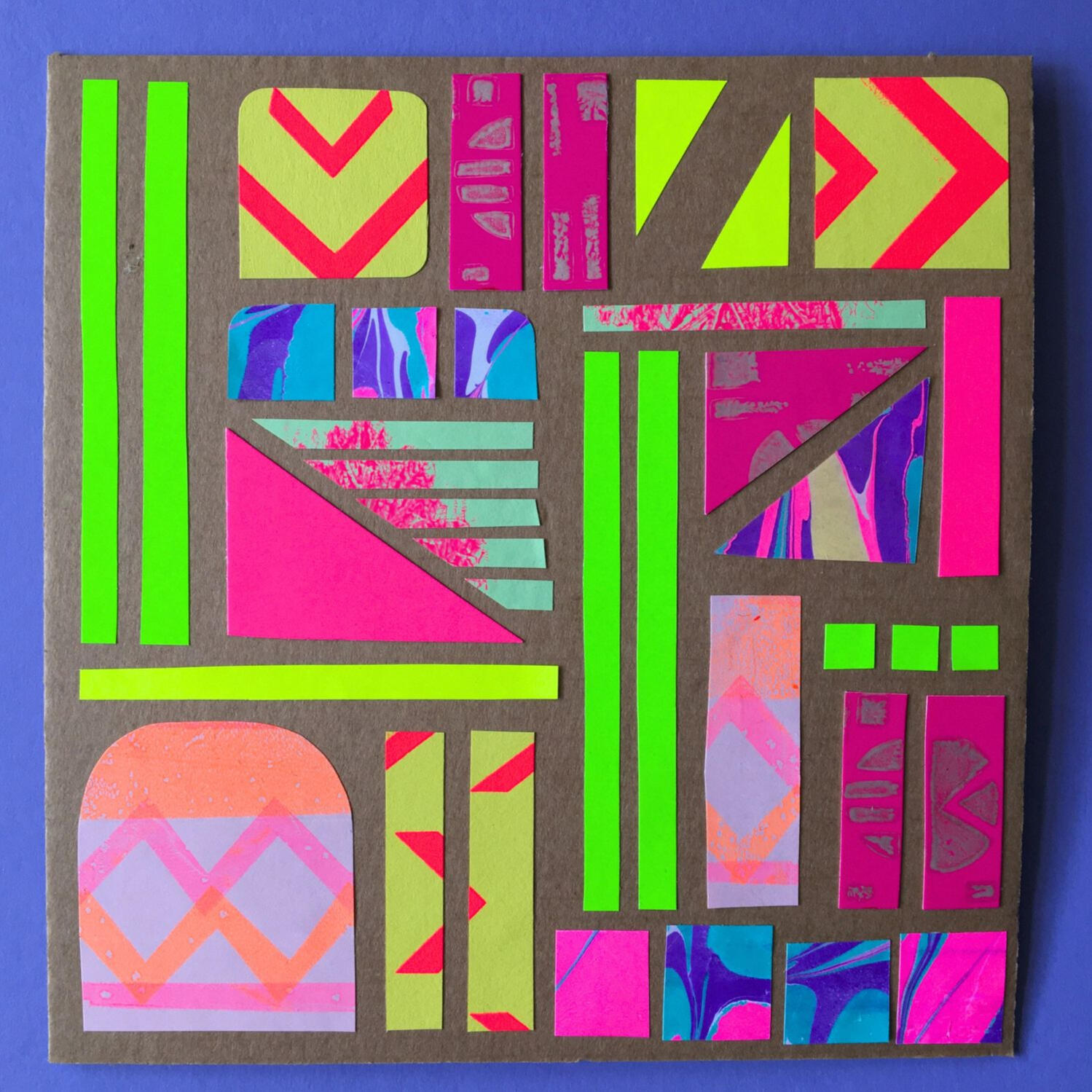 Adult and child hands creating colourful paper collages at a family arts and crafts workshop