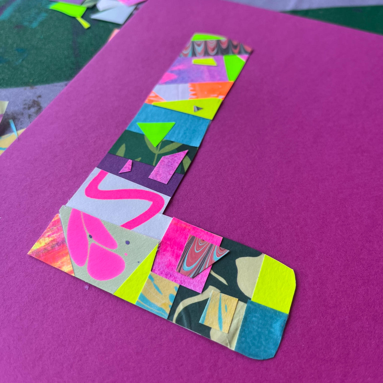 Gel printed paper stencil design printed onto a purple background as inspiration for a gelli printing club.